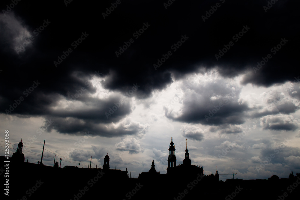 
Shadow siluette of the city skyline dresden with dark storm clouds 