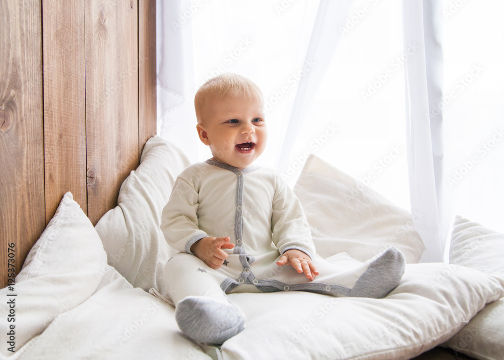 Fototapeta premium Little baby smiling and looking away