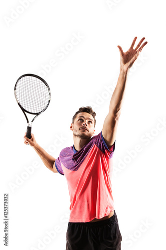 Male tennis player with racket ready to hit a tennis ball