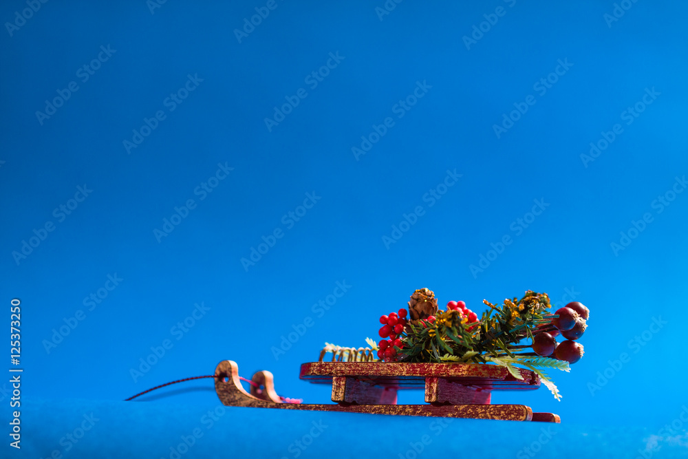 Christmas card with decorative sledge standing on blue background. Christmas card with decorative sledge standing on blue background.