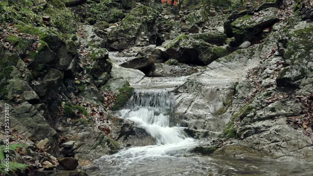 Clear and transparent waterfall flows in the mountains Clear and transparent waterfall flows in the mountains