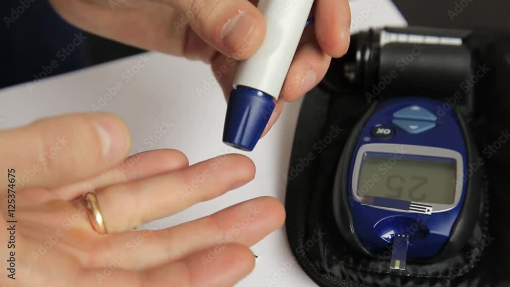 Measuring glucose level blood test using ultra mini glucometer and small drop of blood from finger and test strips. Dependent first type diabetes patient. Measuring glucose level blood test using ultra mini glucometer and small drop of blood from finger and test strips. Dependent first type diabetes patient.