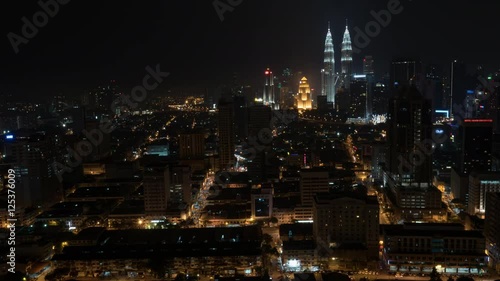 Wallpaper Mural Timelapse shot of Kuala Lumpur at night, Malaysia. Big illuminated metropolis with transport traffic and Petronas Twin Towers dominating over the city Torontodigital.ca
