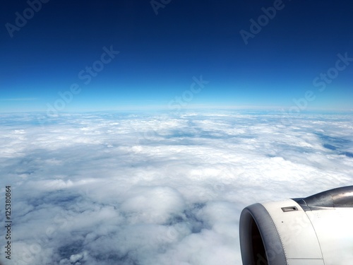 Blue  sky with clouds as seen through window of an aircraft