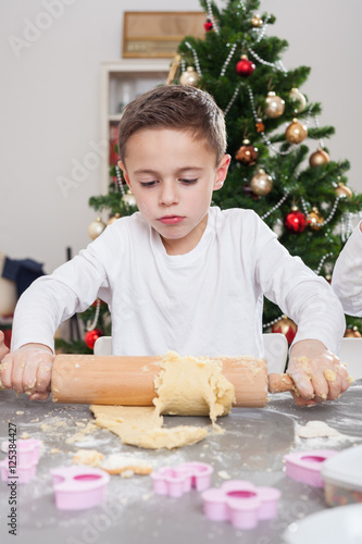 boy bakes christmas cookies