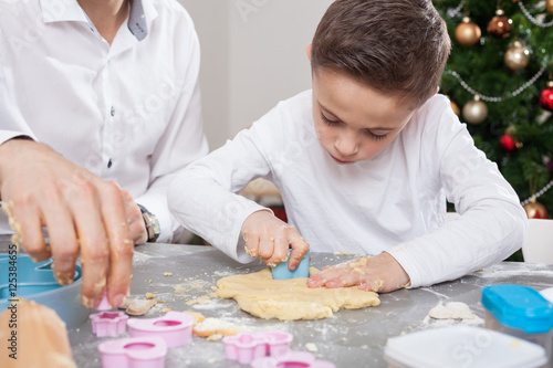 boy bakes christmas cookies