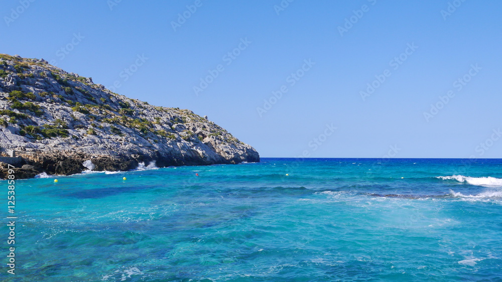 Azure sea and rocky cape