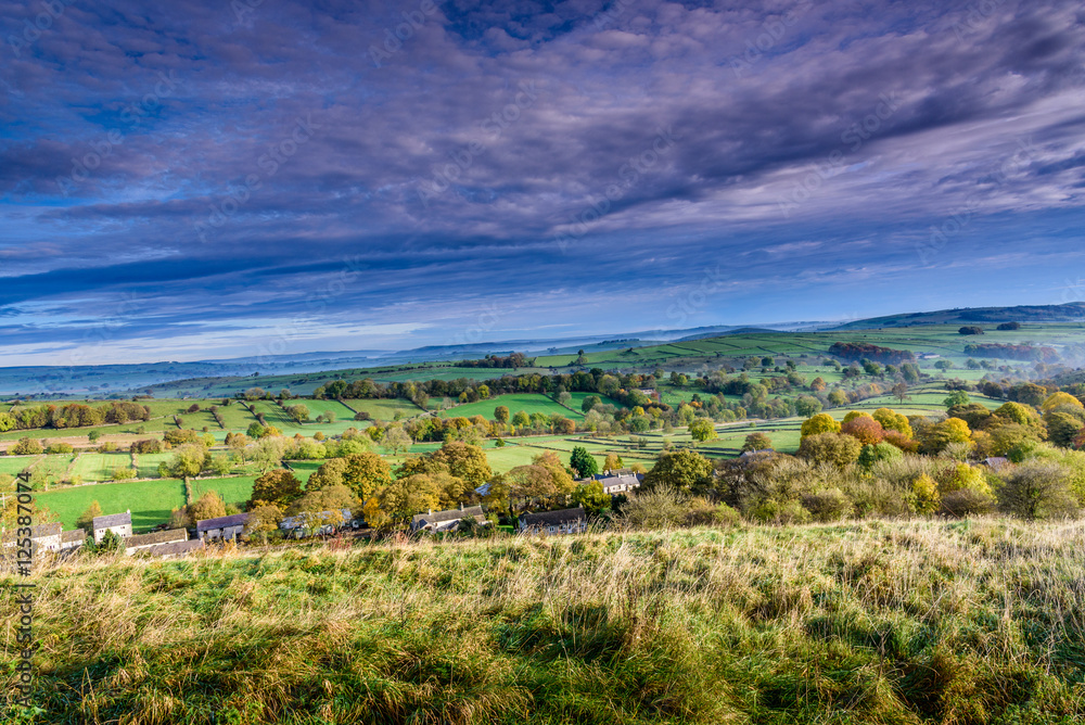 Beautiful countryside landscape near Taddington in Derbyshire, UK - typical English panorama of a rural area, mist in the far background - wide panoramic shot