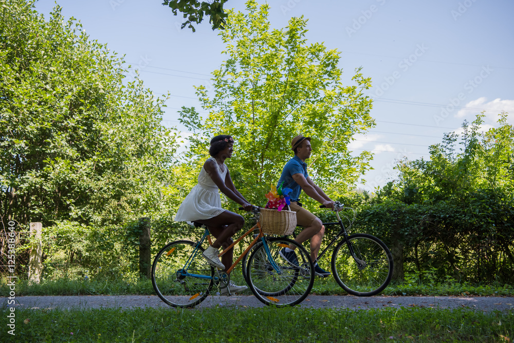 Obraz premium Young multiethnic couple having a bike ride in nature