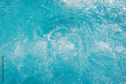 Ripple Water in swimming pool with sun reflection