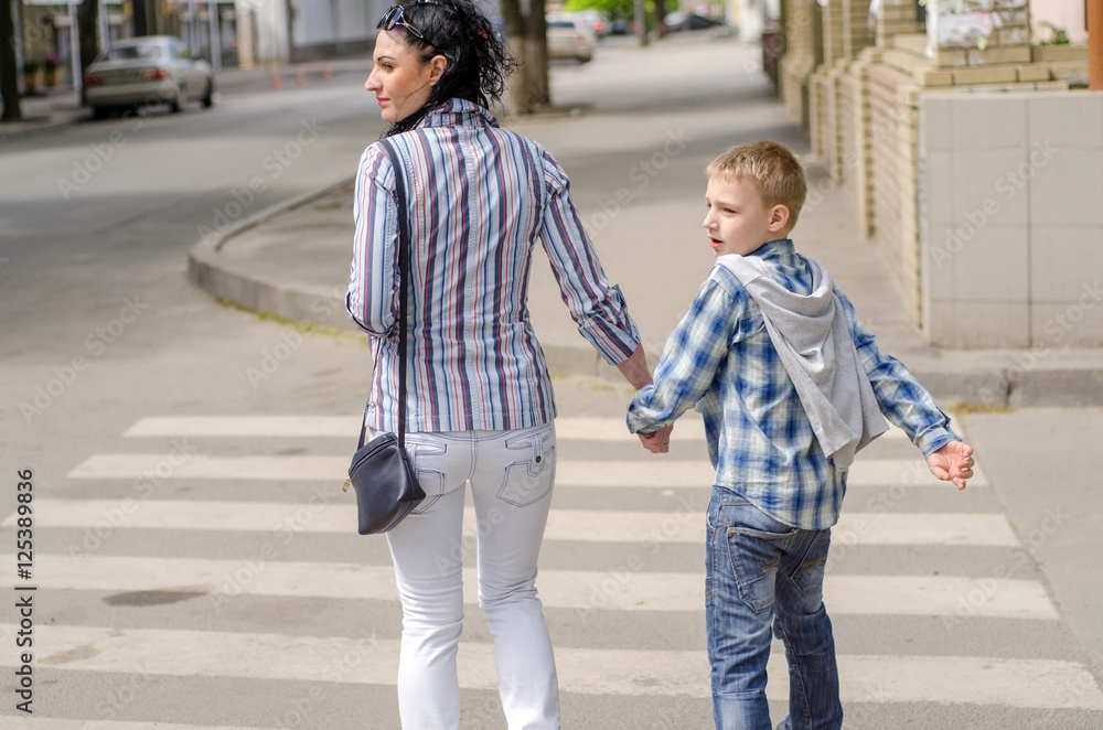 young girl walking in the city with her son