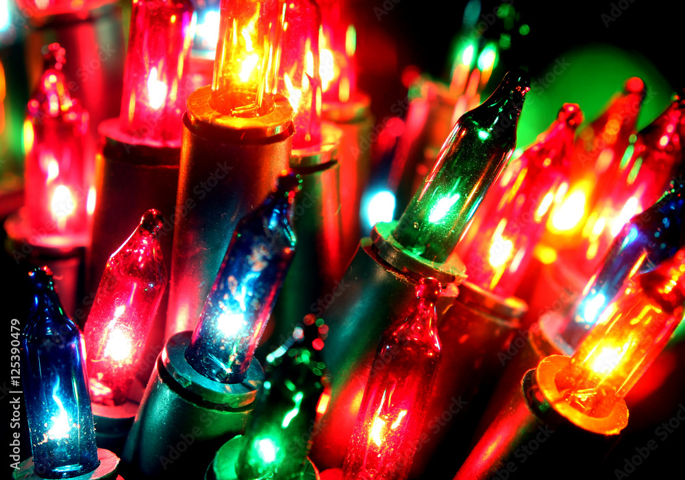 Close up Christmas, New Years garland colorful lights with bokeh dark background Close up Christmas, New Years garland colorful lights with bokeh dark background