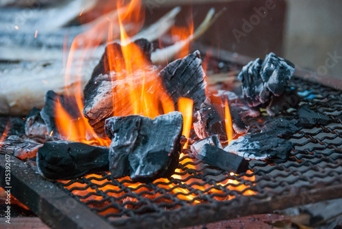 Flames and fish on grill.