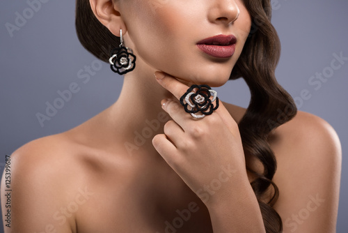 Gorgeous woman with precious jewelry in studio
