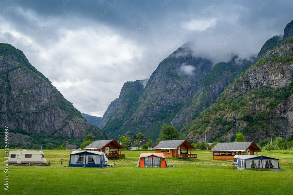 Norwegian camping houses under the high mountains of Eidfjord.