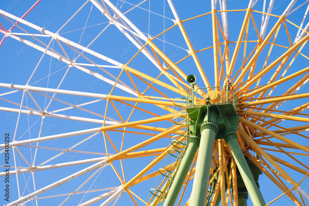 Fototapeta premium Ferris wheel close up with blue sky in amusement park
