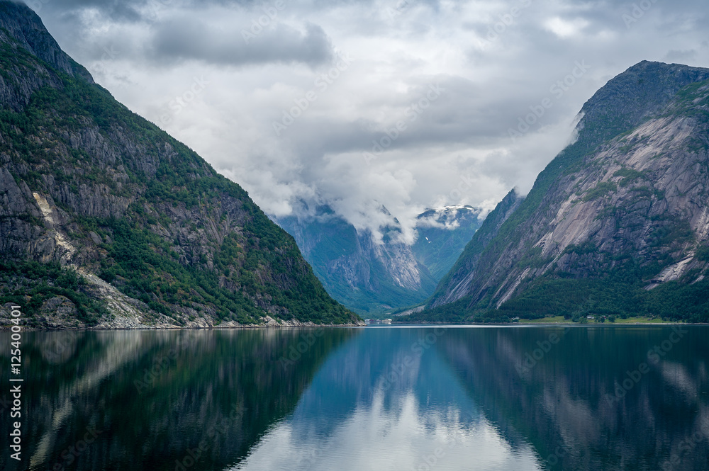 Norway fjord scenic landscape of Eidfjord with mountain reflections on the water.