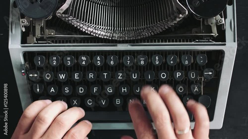 Writer typing with retro writing machine. View from above. photo