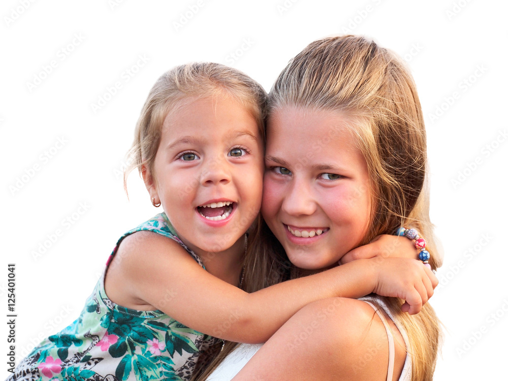 Two sisters fun hugging and looking into the camera. Two sisters fun hugging and looking into the camera.