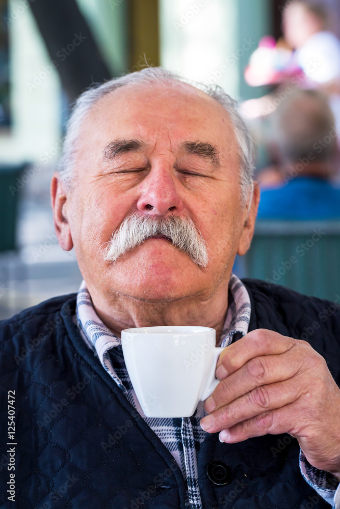 Elderly man with cup of coffee at summer cafe Elderly man with cup of coffee at summer cafe