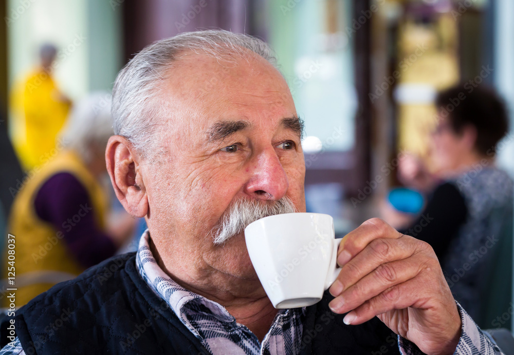 Elderly man with cup of coffee at summer cafe Elderly man with cup of coffee at summer cafe