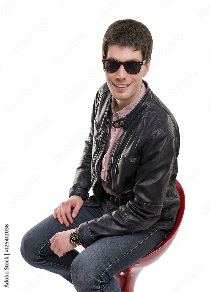 Friendly young man sitting on the bar stool. Friendly young man sitting on the bar stool.