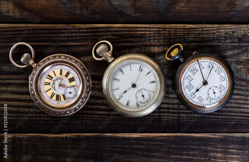 Old pocket watch on grungy wooden desk. Old pocket watch on grungy wooden desk.