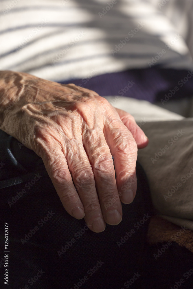 Hand of an elderly woman. Wrinkles.