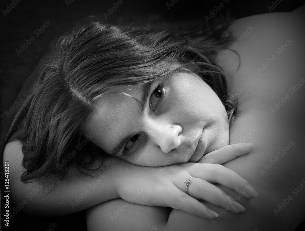 Young overweight girl thinking about her problem. Mental health and body care theme. People and theirs troubles. Black and white photography. Young overweight girl thinking about her problem. Mental health and body care theme. People and theirs troubles. Black and white photography.