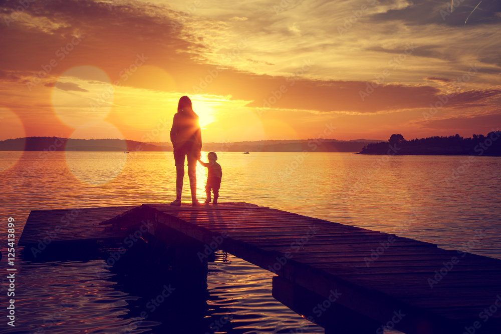 Silhouettes of Mother and Her Son by the Lake Silhouettes of Mother and Her Son by the Lake