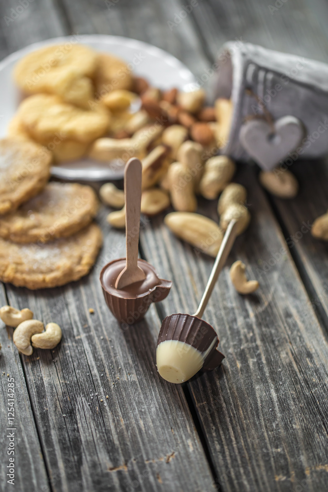 chocolate and nuts on wooden background chocolate and nuts on wooden background