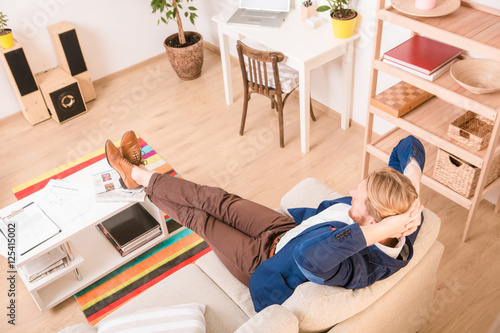 Portrait of rich European businessman resting and relaxing at home. Hnadsome man enjoying free time at weekends. photo