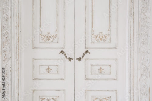 Old-style door, white - handle closeup. antiques interior