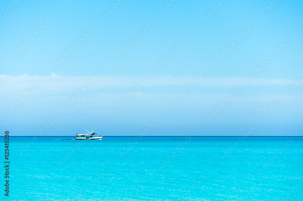 Boat sailing on blue Caribbean sea
