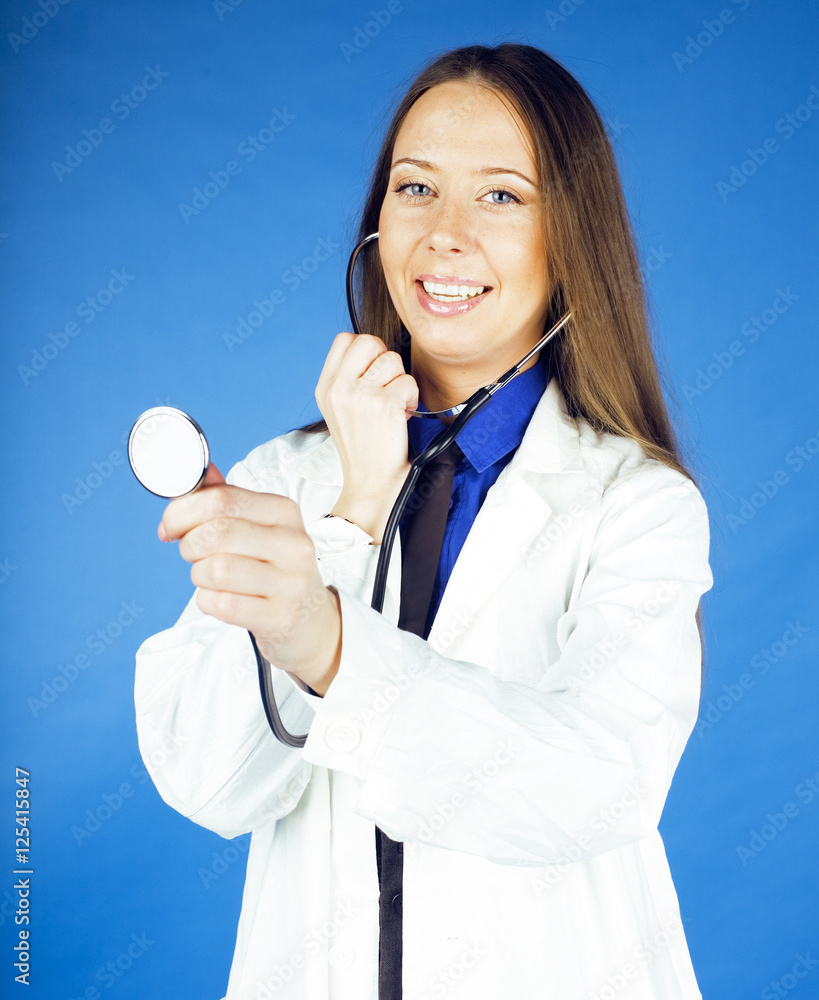 young pretty woman doctor with stethoscope on blue background smiling young pretty woman doctor with stethoscope on blue background smiling