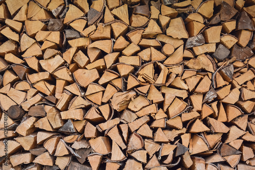Firewood stacked in a woodpile, close-up