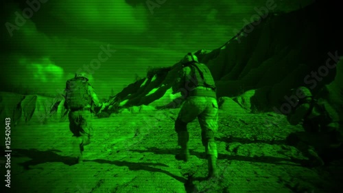 Looking through Night Vision Glasses how Group of Soldiers Running During Night Military Operation. photo