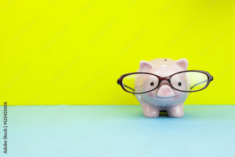 Pink piggy bank with glasses