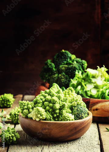 Green cauliflower, old wooden background, selective focus
