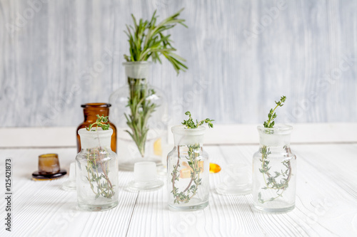 concept - natural medicine herbs in bottles on wooden background