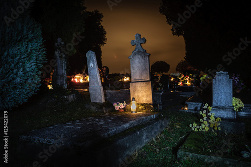 Cemetery halloween night.Grave candles 