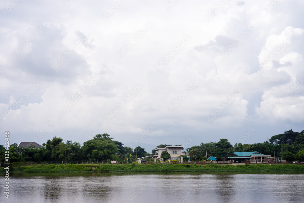 landscape house near river in cloudy day