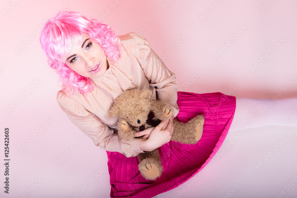 childlike woman with teddy bear toy