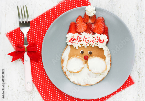 Funny santa pancake with mascarpone and strawberry