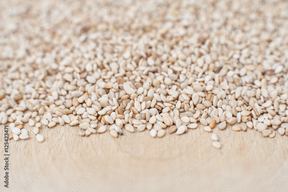 Sesame seeds coastline on wooden plate Sesame seeds coastline on wooden plate