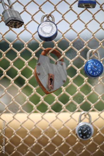 Heart Shaped Pad Lock or Love Lock on a chain link fence