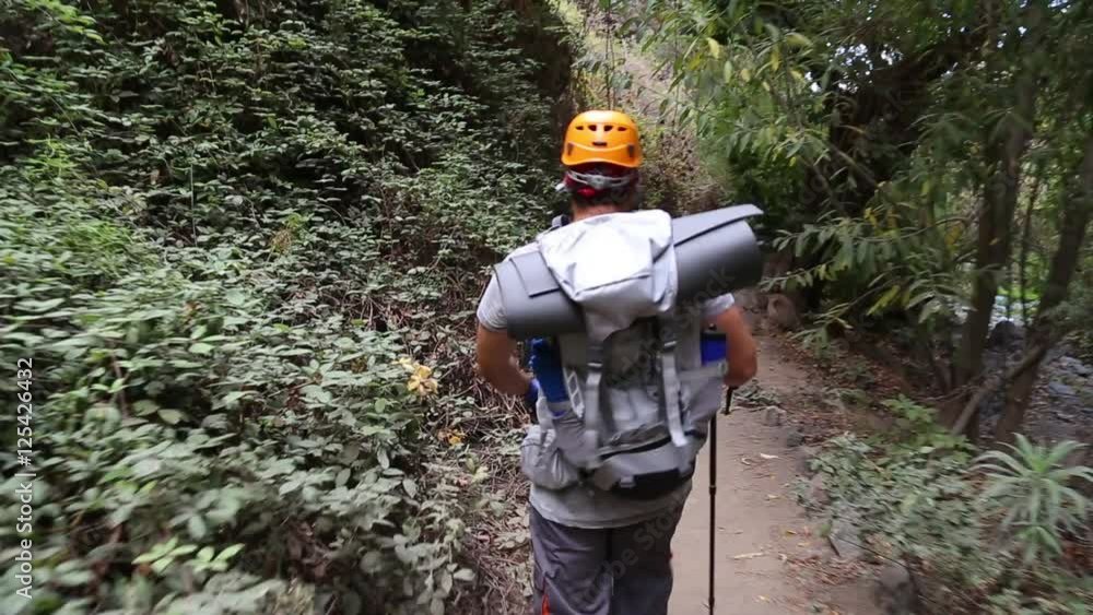 Backpacker man hiking in beautiful landscapes of Barranco del Infierno in Tenerife. Canary islands, Spain Backpacker man hiking in beautiful landscapes of Barranco del Infierno in Tenerife. Canary islands, Spain