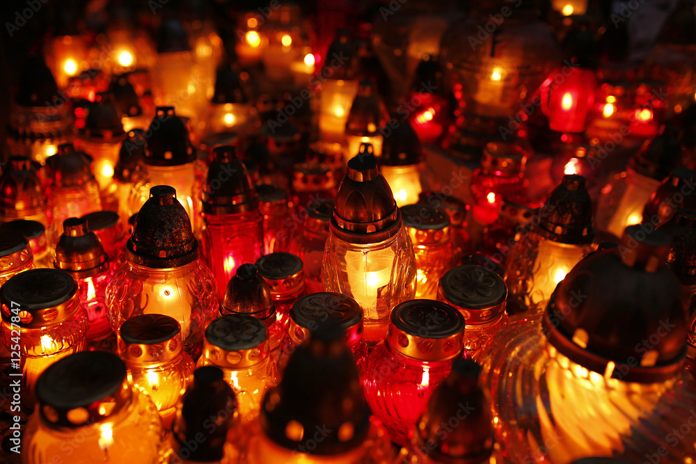 closeup of burning candles at the cemetery on All Saints' Day closeup of burning candles at the cemetery on All Saints' Day