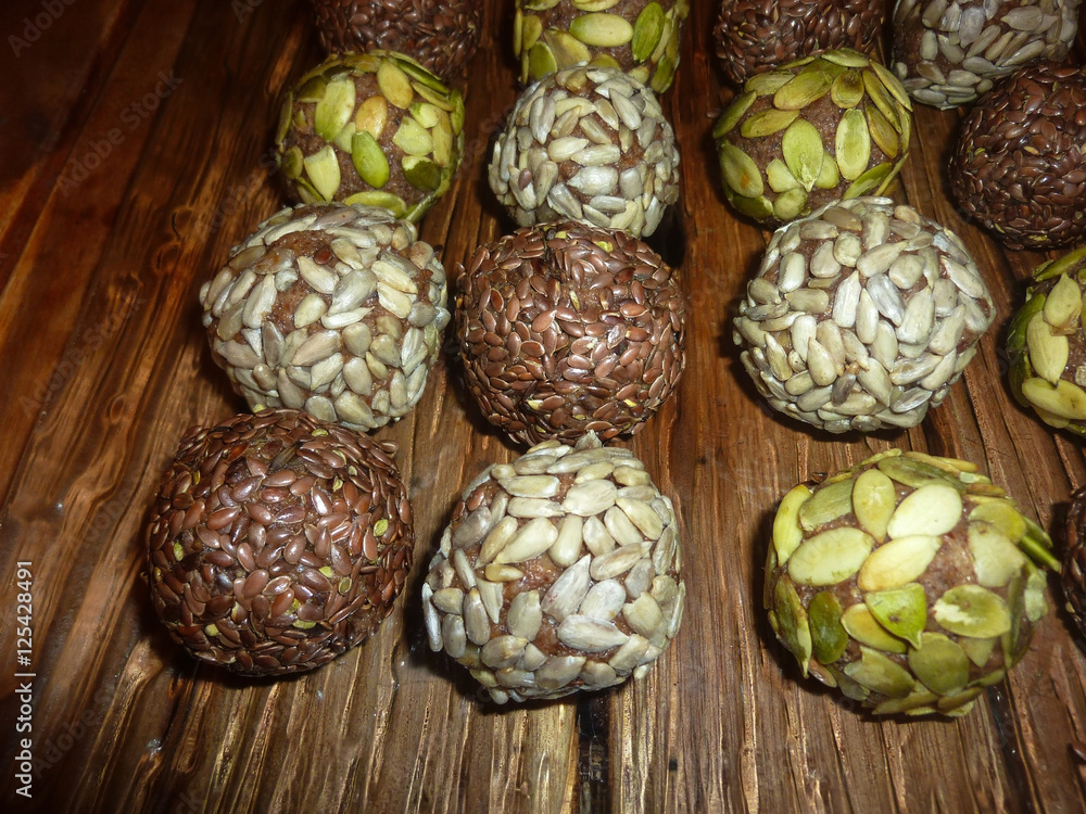 Candy of dried fruits and nuts. Healthy eating. raw food on a wooden table. Candy of dried fruits and nuts. Healthy eating. raw food on a wooden table.