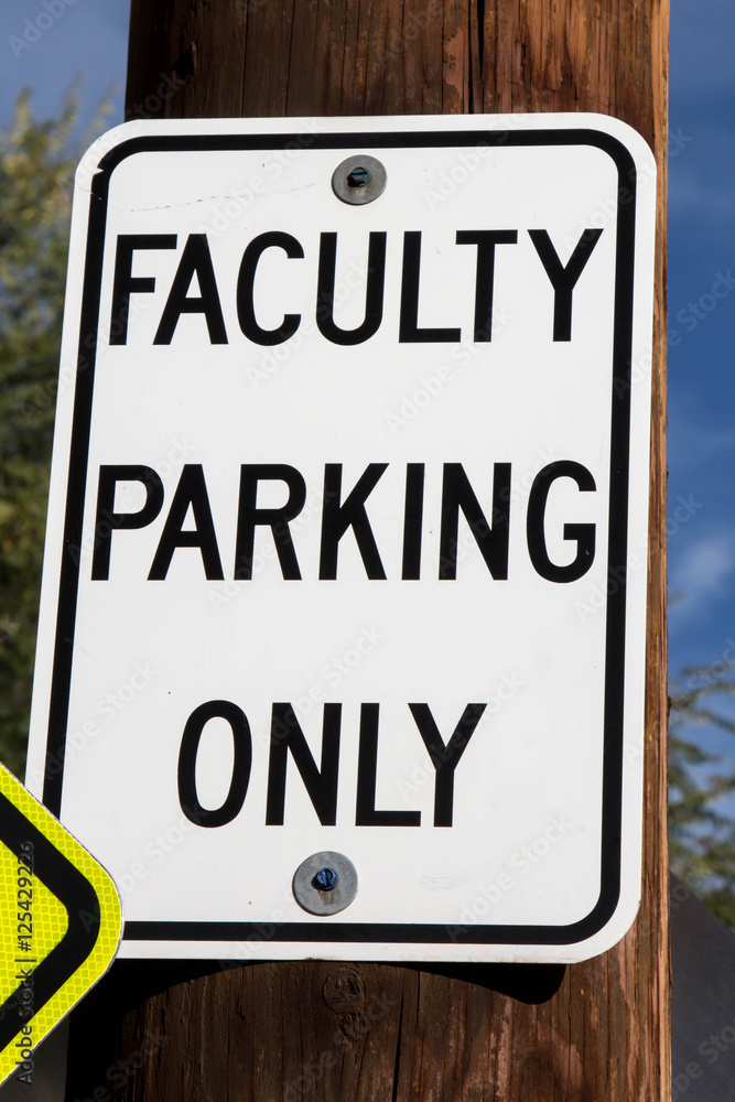 Faculty Parking only sign posted in a school parking lot